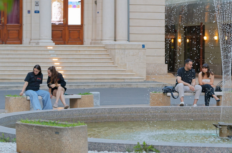 29 - Tourists resting on marble benches in downtown Bucharest